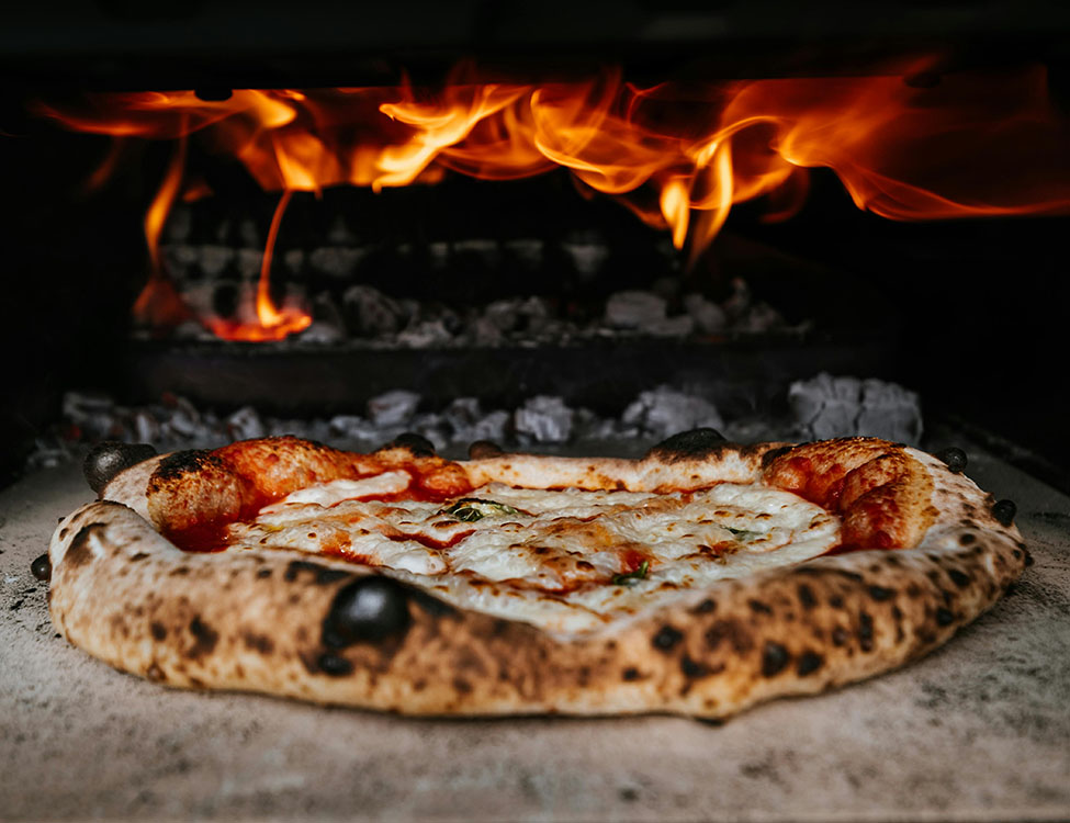 Pizza in a woodfire oven.